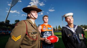 Corporal Jordan Smyth, Giant Tom Green, and Leading Seaman Stephanie Went at Manuka Oval. Picture by Sitthixay Ditthavong