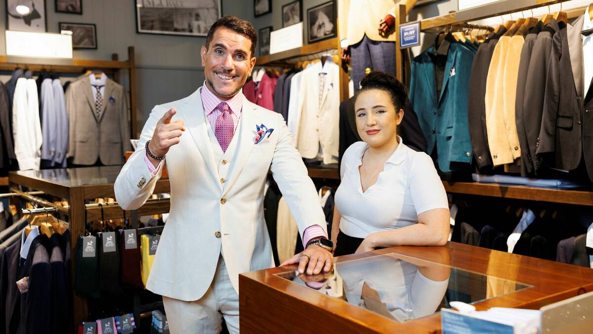 Nick Risteski, being dressed by MJ Bale area manager Sarah Paine, tries out his race-day wear, an autumn-inspired pink and white suit. Picture by Keegan Carroll