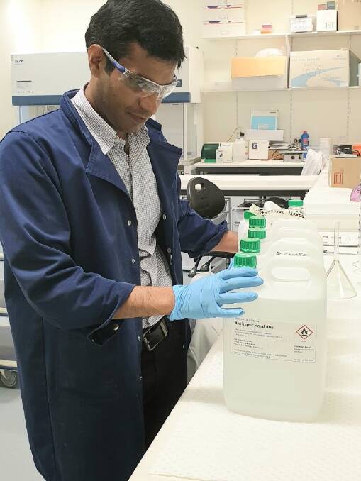 Dr Zahid Hussain, lecturer in pharmaceutical science at University of Canberra, helps make hand sanitiser.