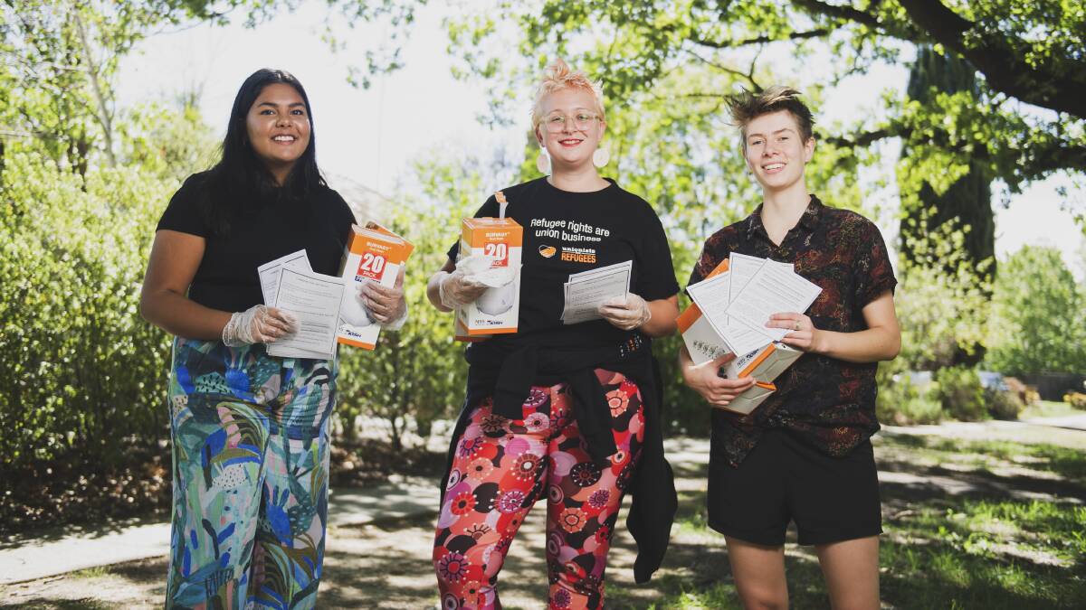 Canberra Region Coronavirus Mutual Aid group members Zoe Ranganathan, Tamara Ryan and Clare Lucre holding free masks and flyers offering help to people across the community during the crisis. Picture: Dion Georgopoulos