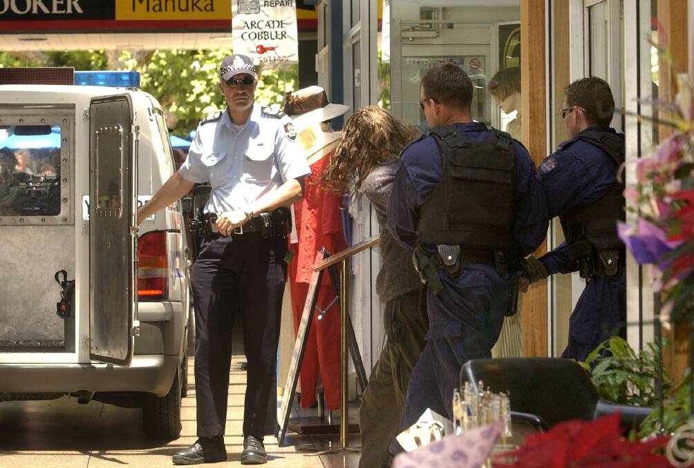 Flashback to the Manuka siege, with police bundling the offender into a van. Picture by Graham Tidy 