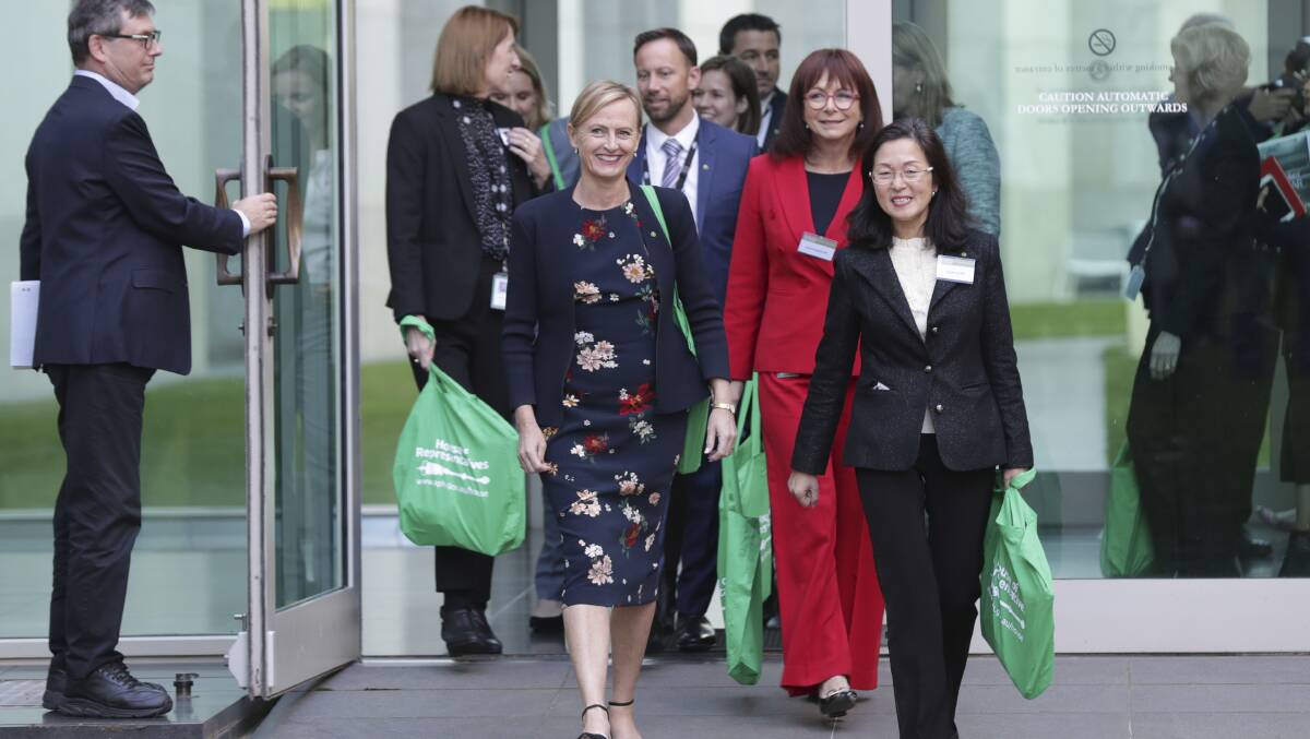 Katie Allen, Gladys Liu and fellow newly-elected Members of the House of Representatives arrive in the courtyard to meet with members of the press gallery on Tuesday. Picture: Alex Ellinghausen
