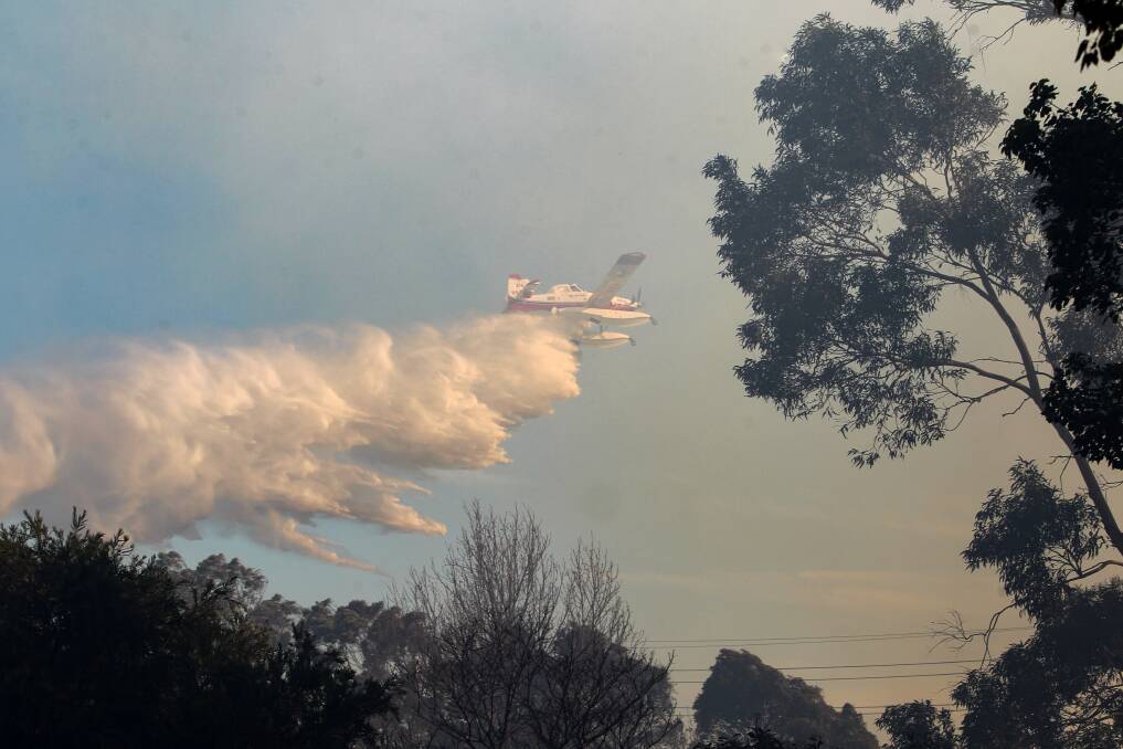 An aircraft helps to fight the fire at North Nowra.  Photo: Adam McLean