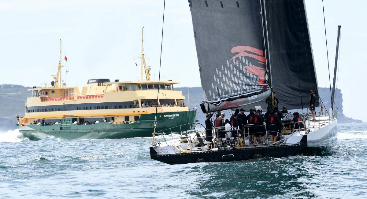 Iconic Sydney: LDV Comanche passes a ferry during a practice sail ahead of the Sydney to Hobart. Photo: AAP