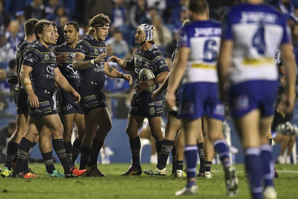 Highs and Lowes: Johnathan Thurston congratulates Ethan Lowe on one of his two tries at Belmore. Photo: Brett Hemmings