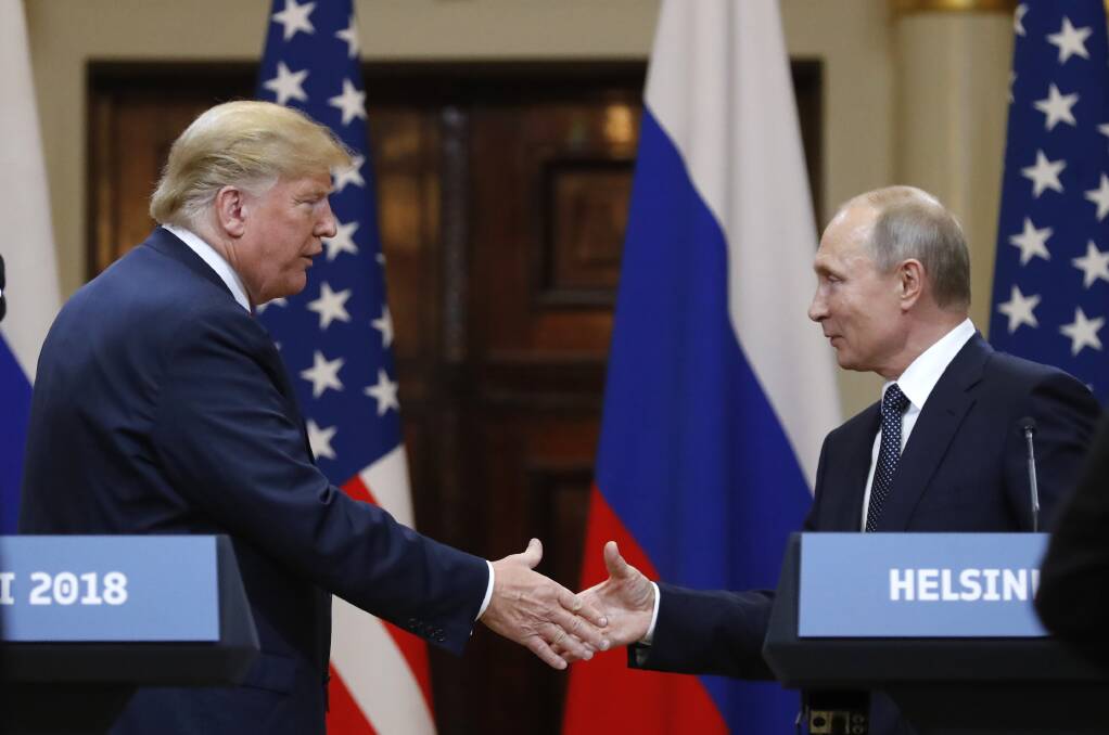 Donald Trump shakes hands with Vladimir Putin in Helsinki. Photo: AP