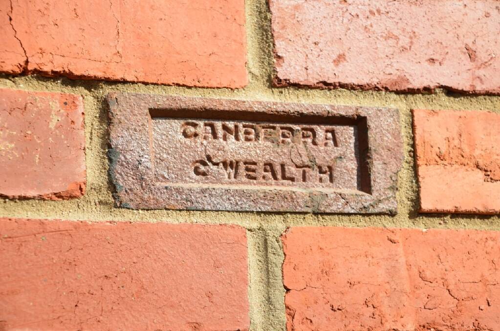  'Canberra red' bricks were salvaged by hand and stacked for cleaning prior to re-use in the new replacement house. Photo: Supplied/Michael Dobbie