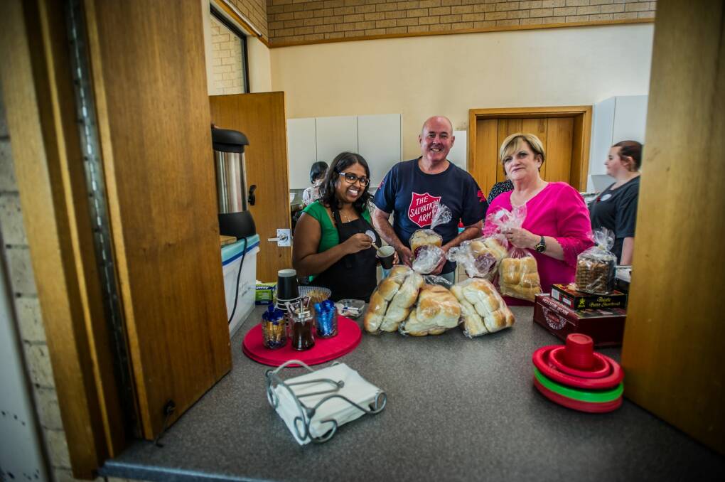 Salvation army volunteers 
Caitlin Naidoo, left, John Hyde and envoy Angela Czoban work at the the Salvation Army, Scullin community lunch. Photo: karleen minney