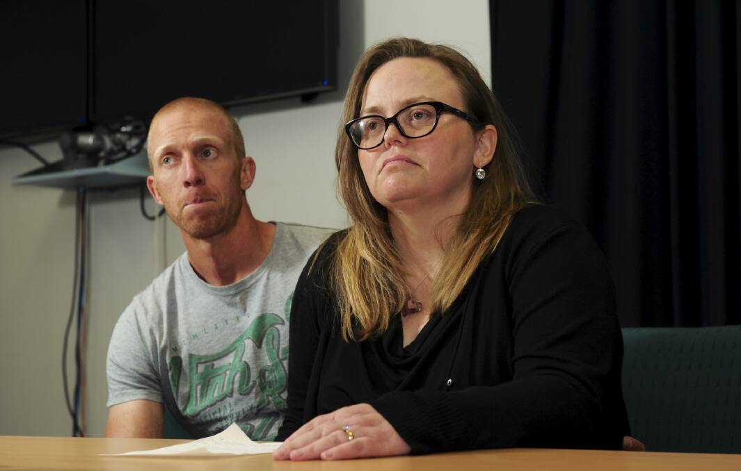 Jenny Heddle, the wife of missing Chisholm man Stuart Heddle,
makes a public plea at the Woden Police Station. At left is Mr Heddle's brother Ian. Photo: Graham Tidy