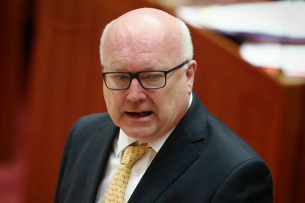 Attorney-General George Brandis will have the power to block legal action or appeal an injunction. Photo: Alex Ellinghausen