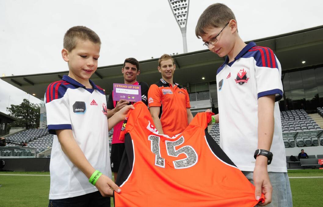 Fraser Murphy,9, of Farrer and his brother Rohan,11, with Sydney Sixers captain Moises Henriques and Adam Voges from the Perth Scorchers. Photo: Melissa Adams