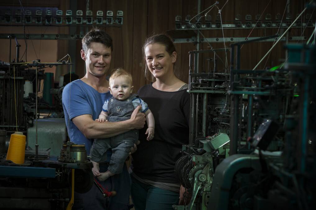 Andrew and Lucy Lindner with their son Arthur, 1, at the family's Crookwell sock-making factory. Photo: Adam McGrath