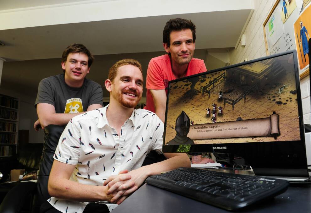 Peter Castle, centre, with fellow creators from left, Peter Simpson and Tom Cox, have developed their game "Tahira" while working in other jobs.  Photo: Melissa Adams