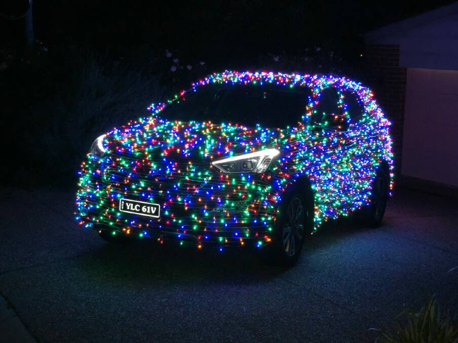 Jordan Wallace and ten friends spent three days rigging up his car, dubbed "Christmas Car", with 4200 light bulbs.  Photo: Supplied