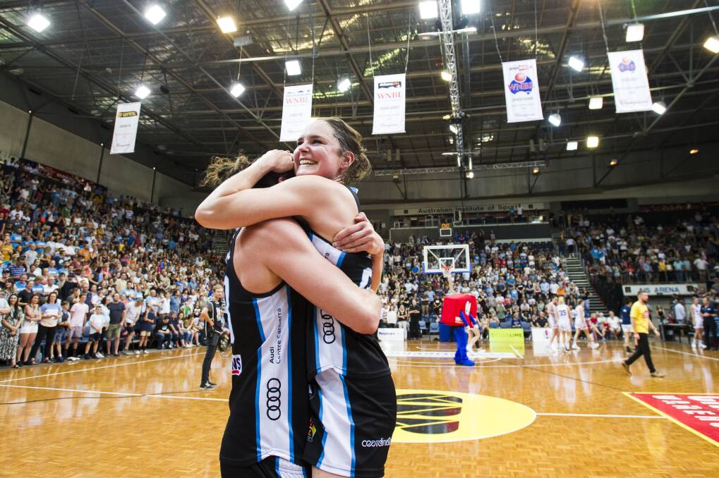 Canberra Capitals celebrate after winning the grand final. Photo: Dion Georgopoulos