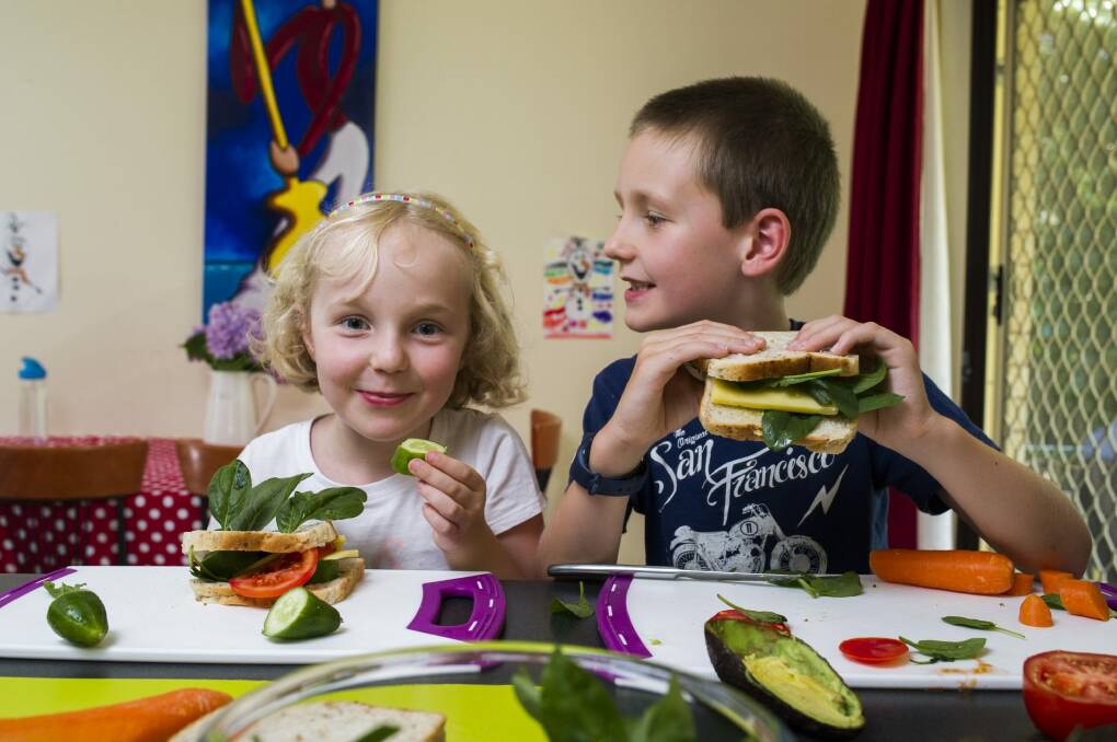 Imogen, 4, and Xavier, 7, Taylor, of Evatt, making healthy sandwiches for lunch.  Photo: Rohan Thomson