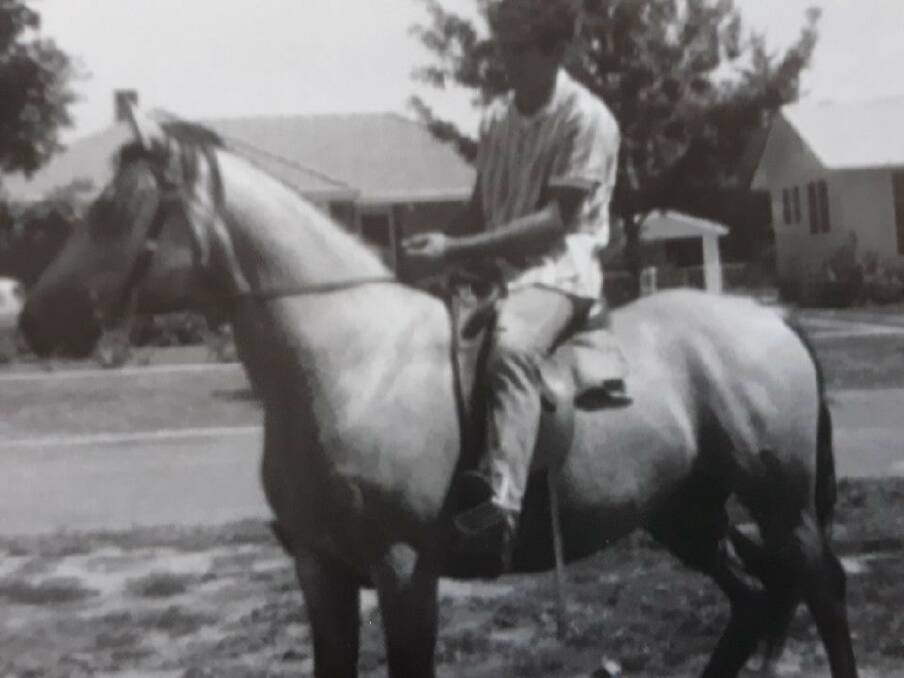 Angelo Costa rides along Warramoo Crescent, Narrabundah, in the early 1960s. Photo: Supplied