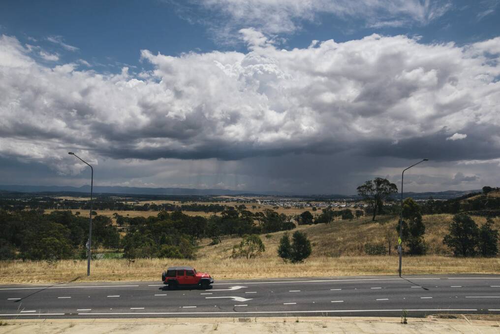 Storm clouds gather as rain falls over Gungahlin in Canberra's north on Wednesday afternoon.  Photo: Rohan Thomson