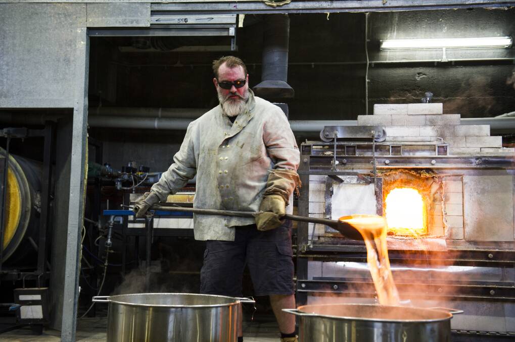 Glass artist and head technician at Canberra Glassworks Tom Rowney emptying out the furnace before he will be shutting down it and replacing it with a new one.  Photo: Dion Georgopoulos