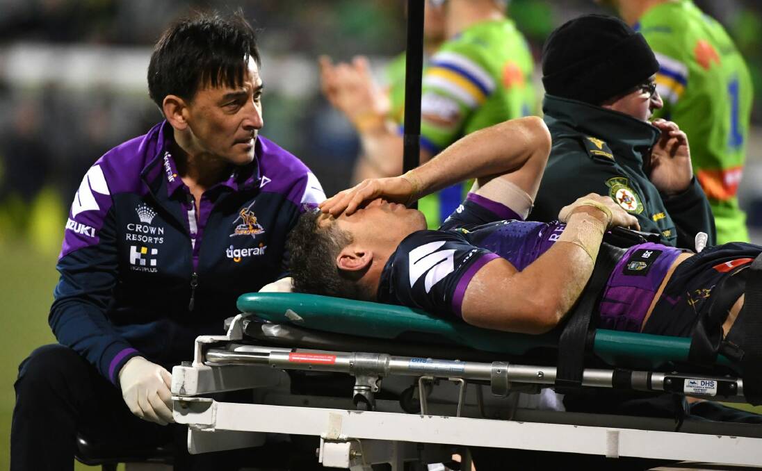 Billy Slater is taken from the field after being collected high by Sia Soliola. Photo: Getty Images