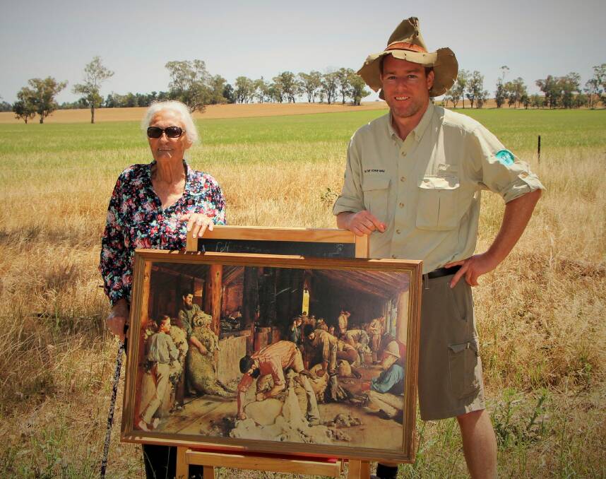 Dorothy Ambrose and Tim the Yowie Man outside the paddock near Corowa where the iconic "Shearing the Rams" was painted. Photo: Dave Moore
