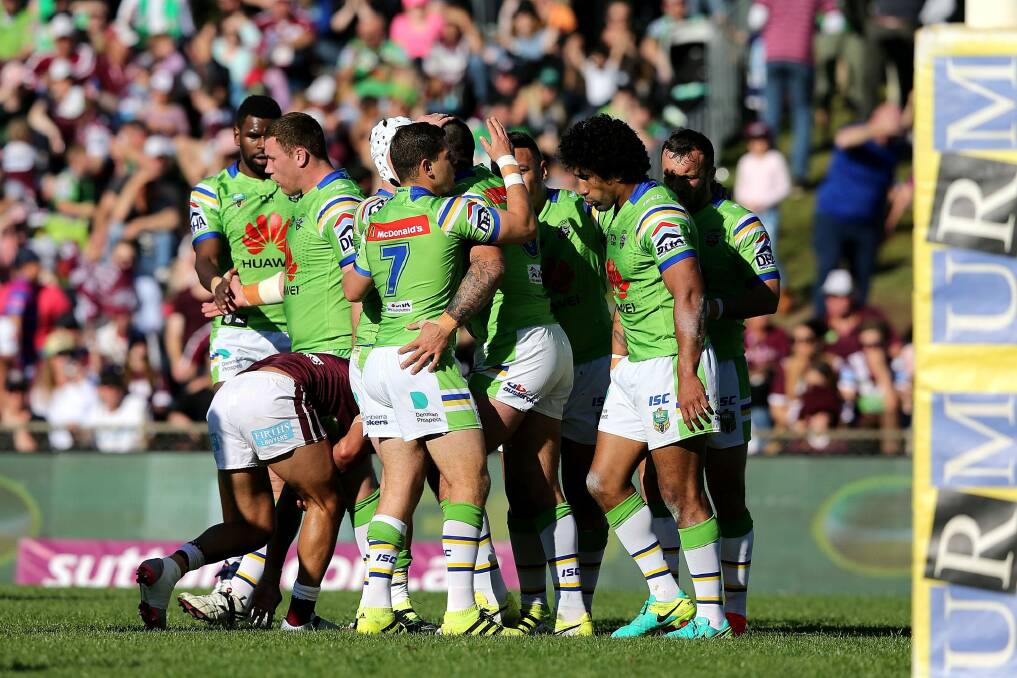 Forward, march: The Raiders celebrate a try from prop Paul Vaughan during the round 25 NRL match. Photo: Ashley Feder