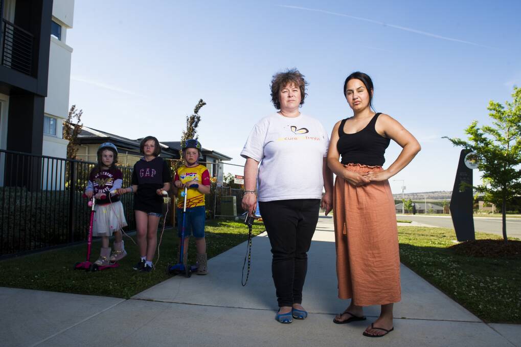 A fire caused by a component of the solar power system in a display home on their street has Denman Prospect residents Lizzie Christiansen and Anita Chatfield worried their homes could burn. Also pictured are Ms Christiansen's children Freyja, 7, Brynn, 11, and Inge, 9. Photo: Dion Georgopoulos