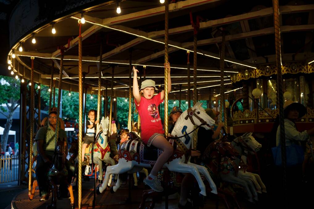 Eleven-year-old Lucinda Stiles traveled with her family from Queanbeyan and took a ride on the carousel before the 9pm fireworks. Photo: Sitthixay Ditthavong