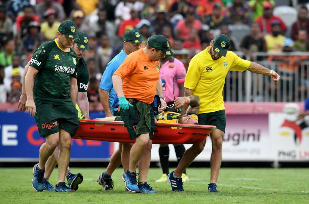 Disastrous: Dylan Walker is taken from the field with a dislocated right ankle. Photo: NRL Photos