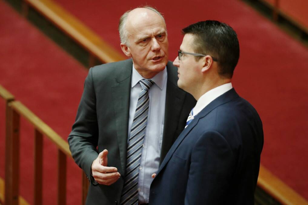 Eric Abetz and Zed Seselja in discussions in the Senate this week. Photo: Alex Ellinghausen