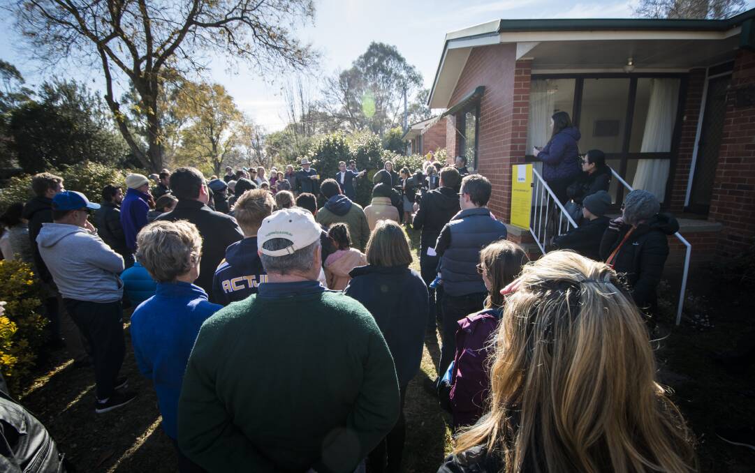 Hundreds of people attended the auction of the Watson home, which sold for $761,000. Photo: Elesa Kurtz