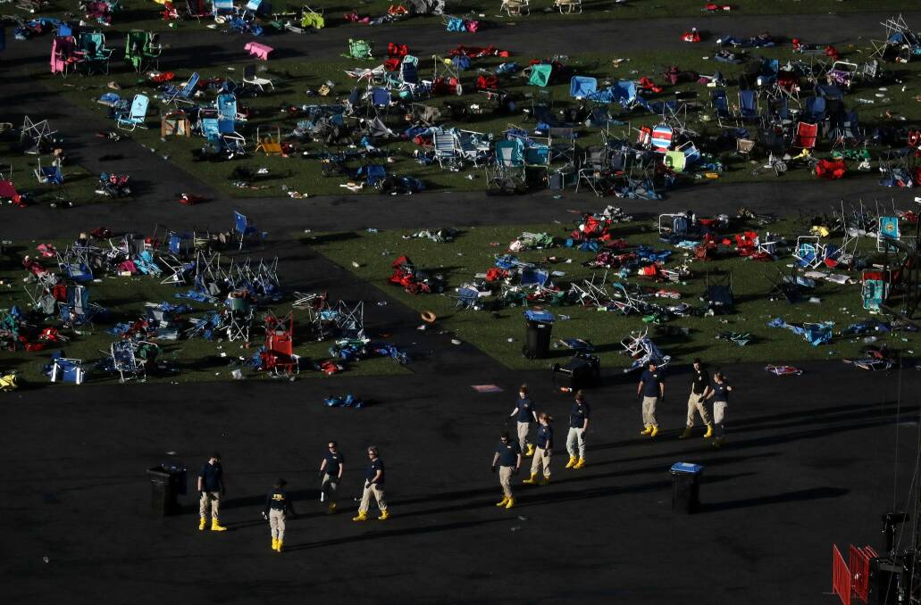 Investigators comb festival grounds across the street from the Mandalay Bay Resort and Casino after  Stephen Paddock opened fire on concertgoers, killing 58 and injuring almost 500. Photo: AP