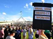 Crowds in Canberra marched to Parliament House to call for action to end violence against women. (Lukas Coch/AAP PHOTOS)
