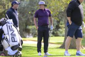 Raiders coach Ricky Stuart and Canberra golf star Matt Millar get to work of raising money for St Vincent de Paul. Picture by Keegan Carroll