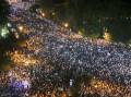 Demonstrators hold up their smart phones with lights during a protest rally in Tbilisi, Georgia. (AP PHOTO)