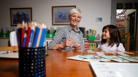 Retired teacher Anna Linard tutors Matilde Pino, 6, in reading. Picture by Elesa Kurtz