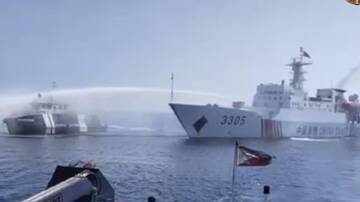 A Chinese ship uses a water cannon on a Philippines vessel at Scarborough Shoal (file pic). (AP PHOTO)
