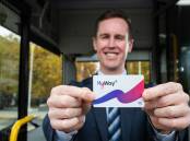 Transport Minister Chris Steel with a new MyWay+ card aboard an electric bus on Thursday. Picture by Elesa Kurtz