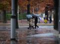 Pedestrians carry umbrellas near Marcus Clarke Street in Canberra. File picture by Elesa Kurtz