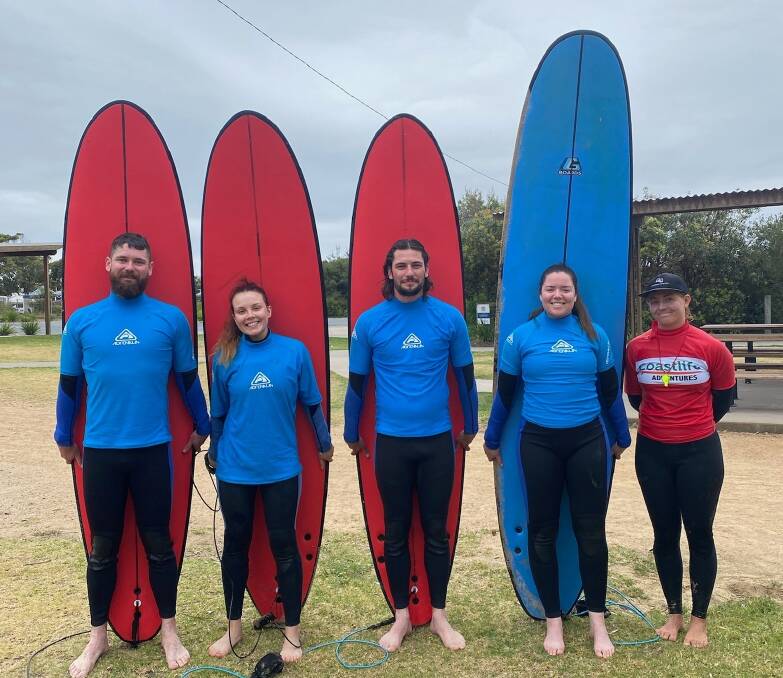 Some Coastlife Adventure surf instructors gathered at Pambula Beach teaching kids how to catch waves on December 29, 2022. 