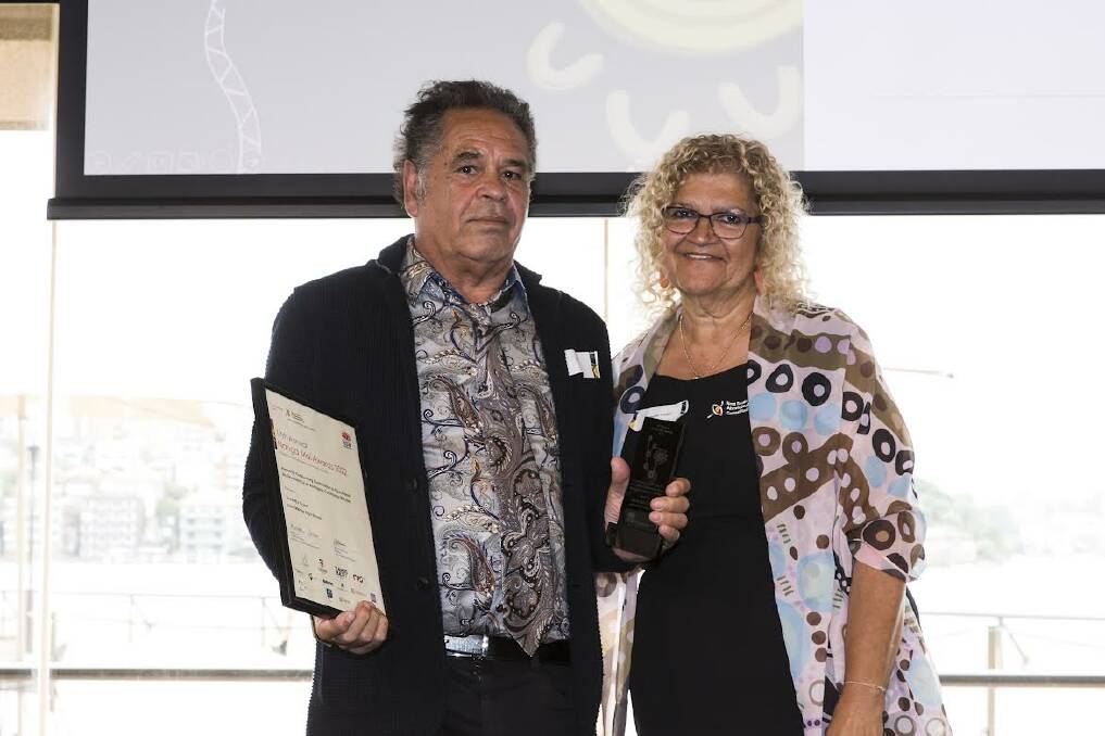 Uncle BJ Cruse is presented with the Outstanding Contribution to Educational Achievement by an Aboriginal Community Member award. Picture supplied. 