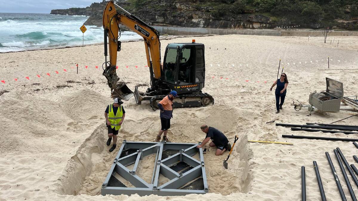 A reinforced steel base lowered into the sand helps keep the sculpture stable. Picture by Ellouise Bailey 