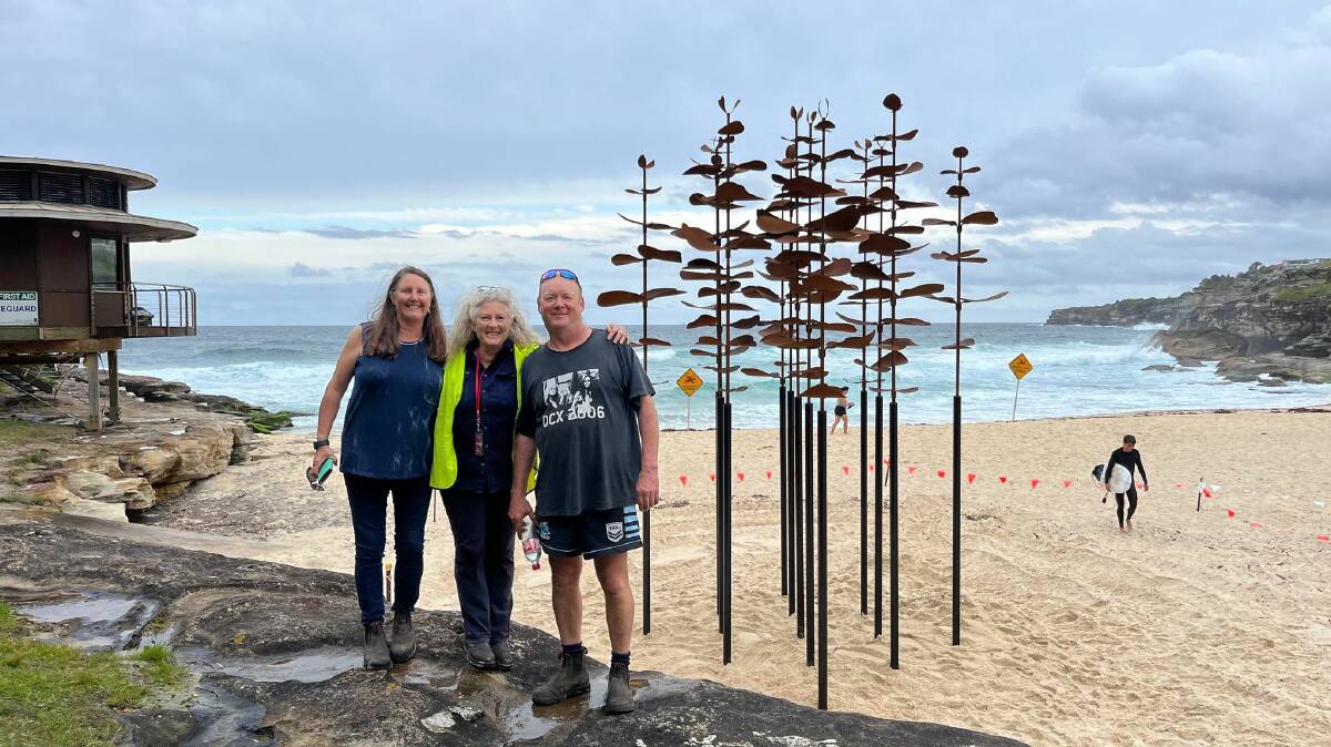 Jo Baxter, Jen Mallinson, and Todd Baxter stand in front of Jen's sculpture Adaption 22 for Sculpture by the Sea exhibition installed at Tamarama Beach, near Bondi Beach in Sydney. Picture supplied 