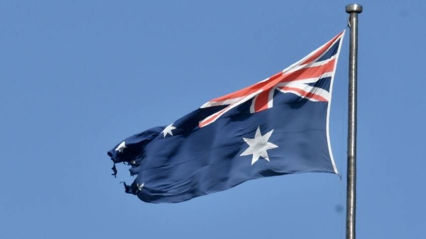 The torn Australian flag at Parliament House. Picture by Elesa Kurtz. 