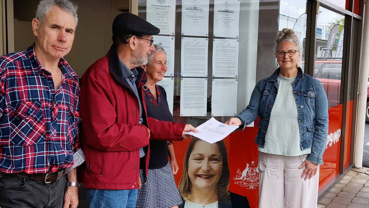 350 Eurobodalla Members Jack Egan, Allan Rees and Marian Matti deliver petition to Maureen Searson at Fiona Phillips' Batemans Bay office. Picture supplied.