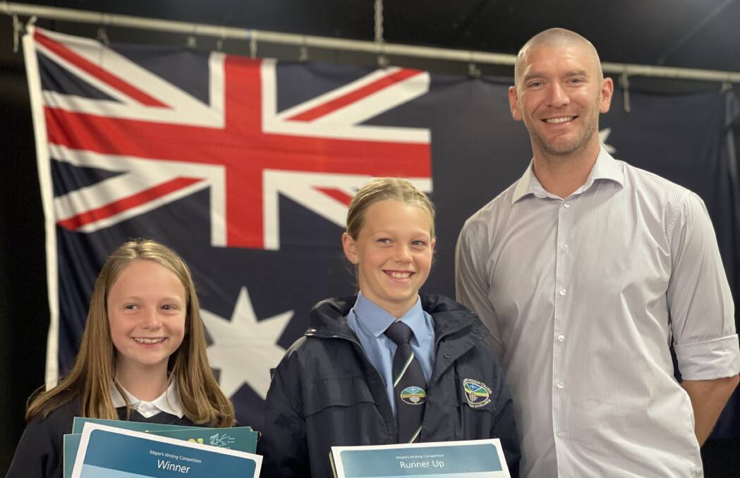 Years 7 & 8 winner Ruby Southan and runner-up Ilah Constable with Mayor Mat Hatcher. Picture by Eurobodalla Shire Council.