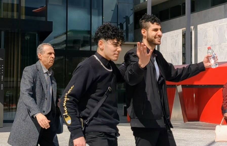 Hamdan (right) walking out of court with supporters on Monday following the verdicts. Picture by Toby Vue.