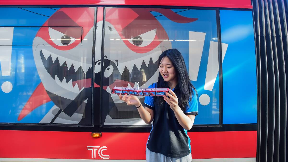 Gungahlin College student Chae Rin with a light rail covered in artwork she created. Picture by Karleen Minney.