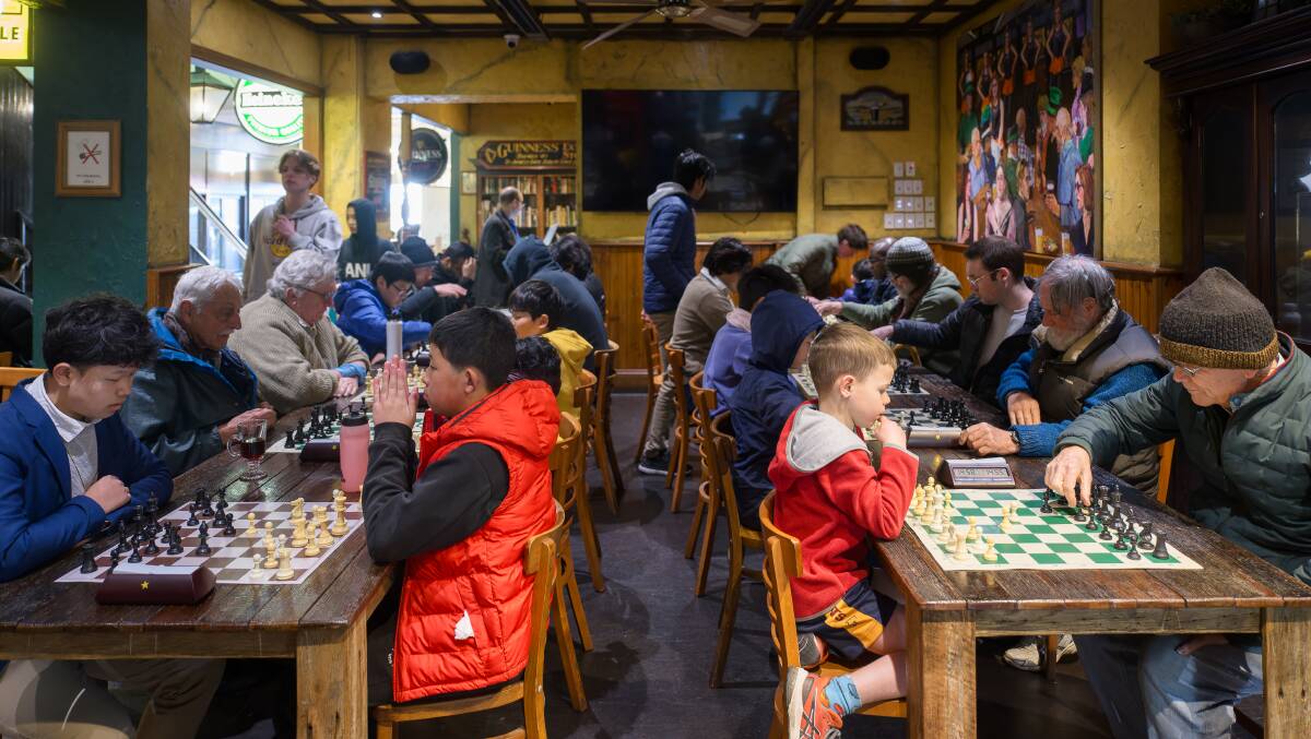 Players take part in an attempt to set a world record for the most number of games of chess in a single day at King O'Malley's. Picture by Sitthixay Ditthavong
