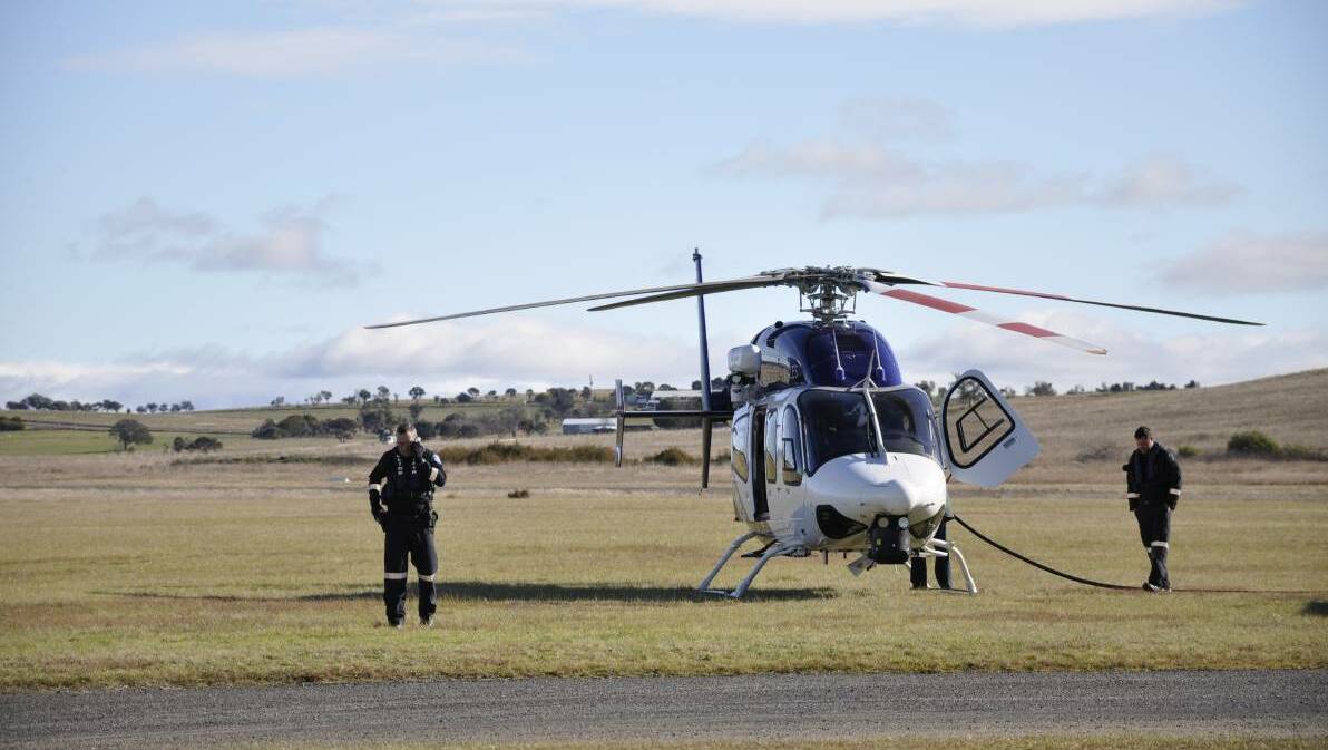 A Polair helicopter at Goulburn Airport on Sunday afternoon as emergency services attended the scene of Sunday's fatal skydiving accident. Picture: Louise Thrower.
